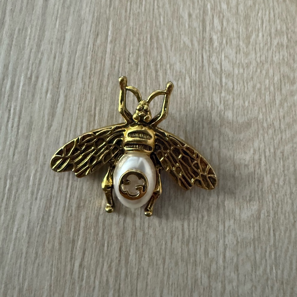 Brand new Gucci Gold and White Bee Brooch Aprox 1.5h by 2”w